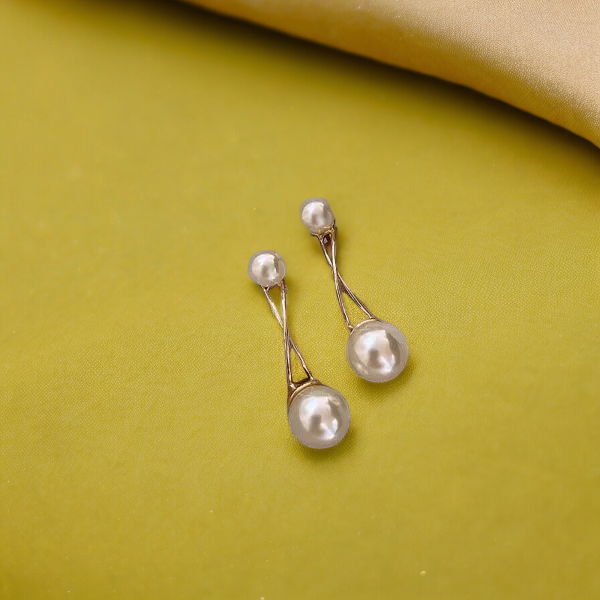 "Close-up of SobPai's elegant imitation pearl dangling earrings with long tassel design.