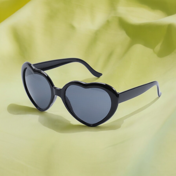 Heart-shaped sunglasses with a Black frame on a yellow background.