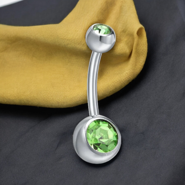 Close-up of SobPai 14G Belly Button Piercing with Green Gem Dangle